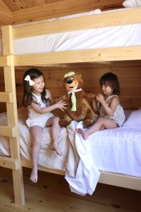 little Girls playing with a stuffed yogi bear